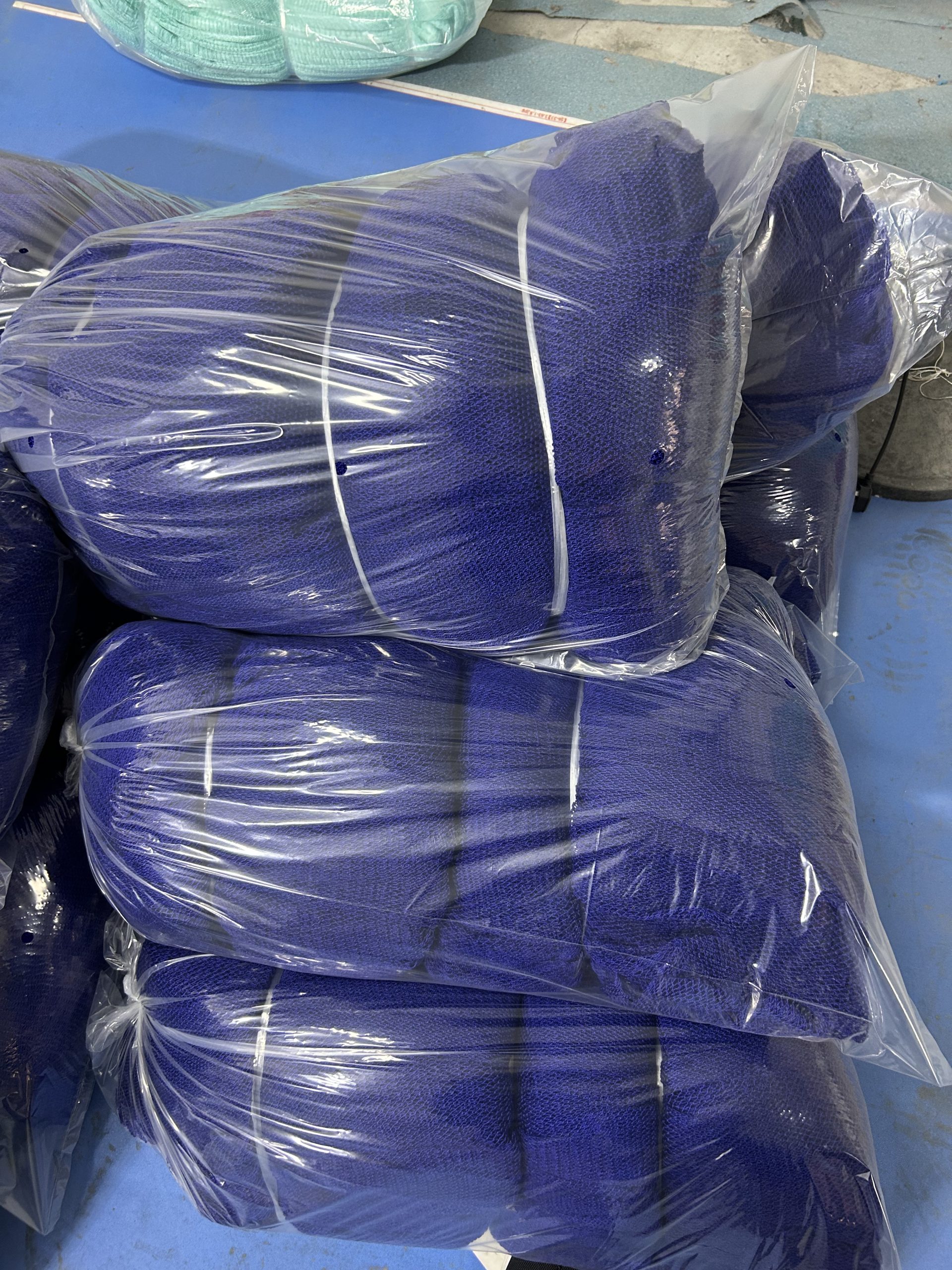 Blue net sponges stacked and bagged for packing